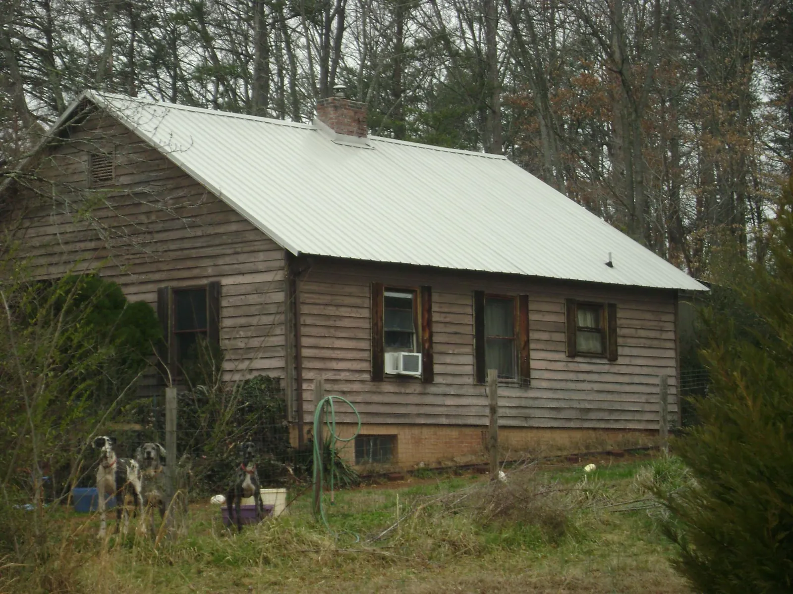 White metal roof on an old wood sided farmhouse, from a Metal Roof Installation job in Chappaqua